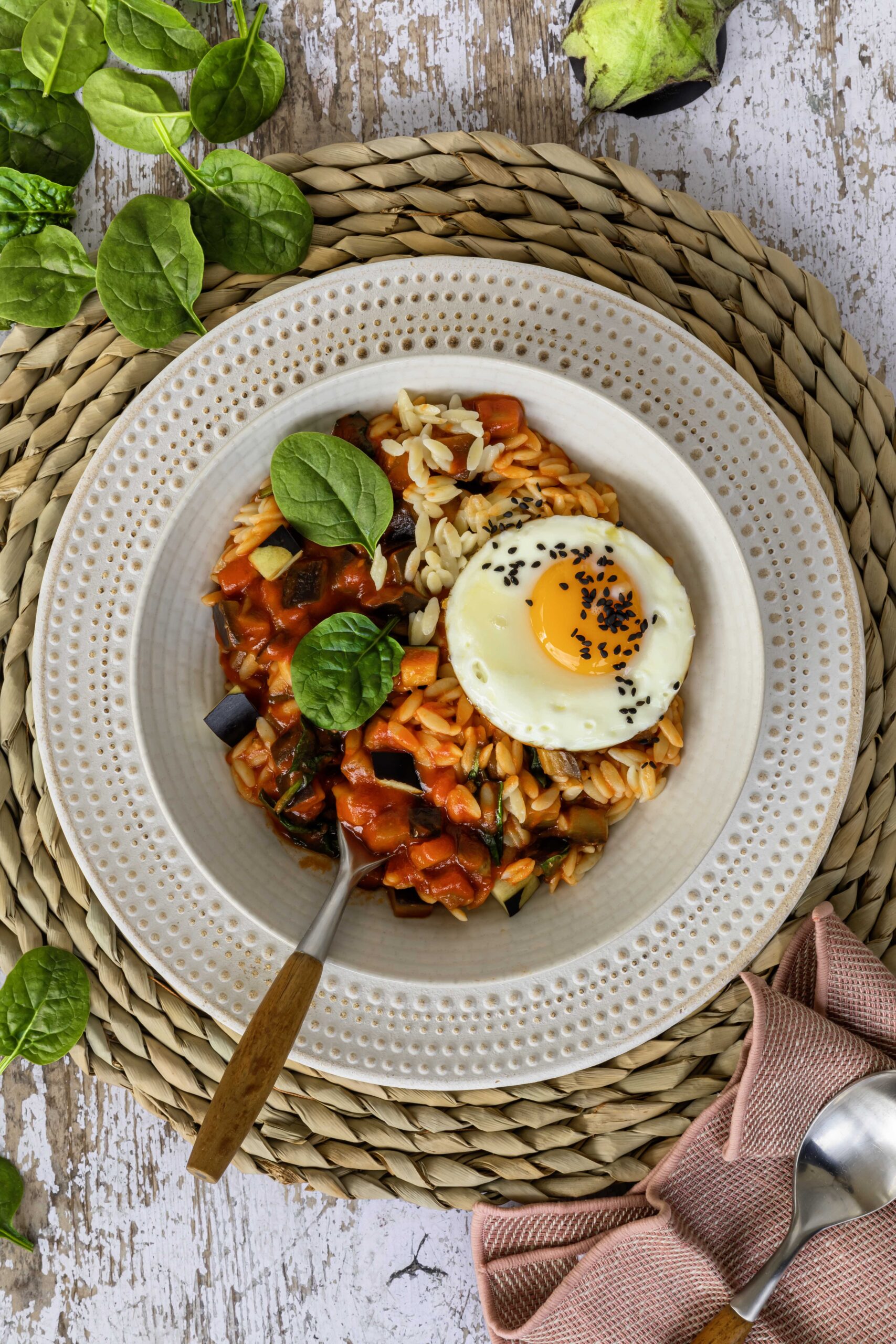 Orzo pasta with tomato, eggplant, spinach and egg