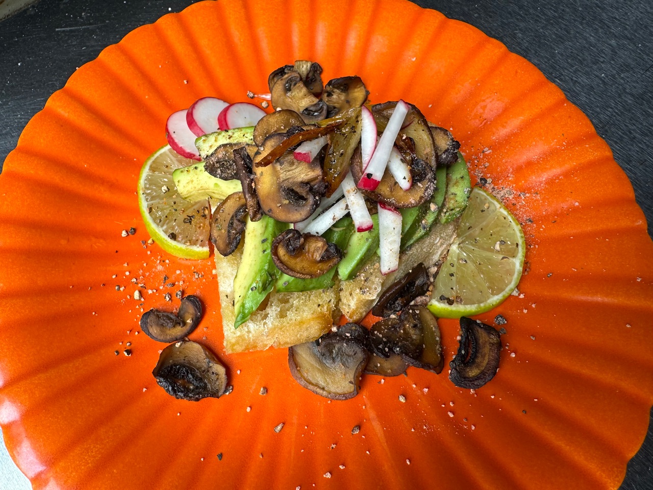 Avocado Toast with Roasted Mushrooms, Caramelized Shallots, Radishes, and Fresh Limes